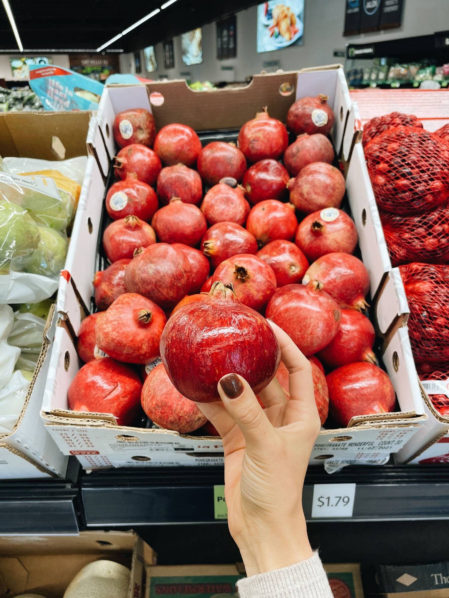 White hand holding pomegranate