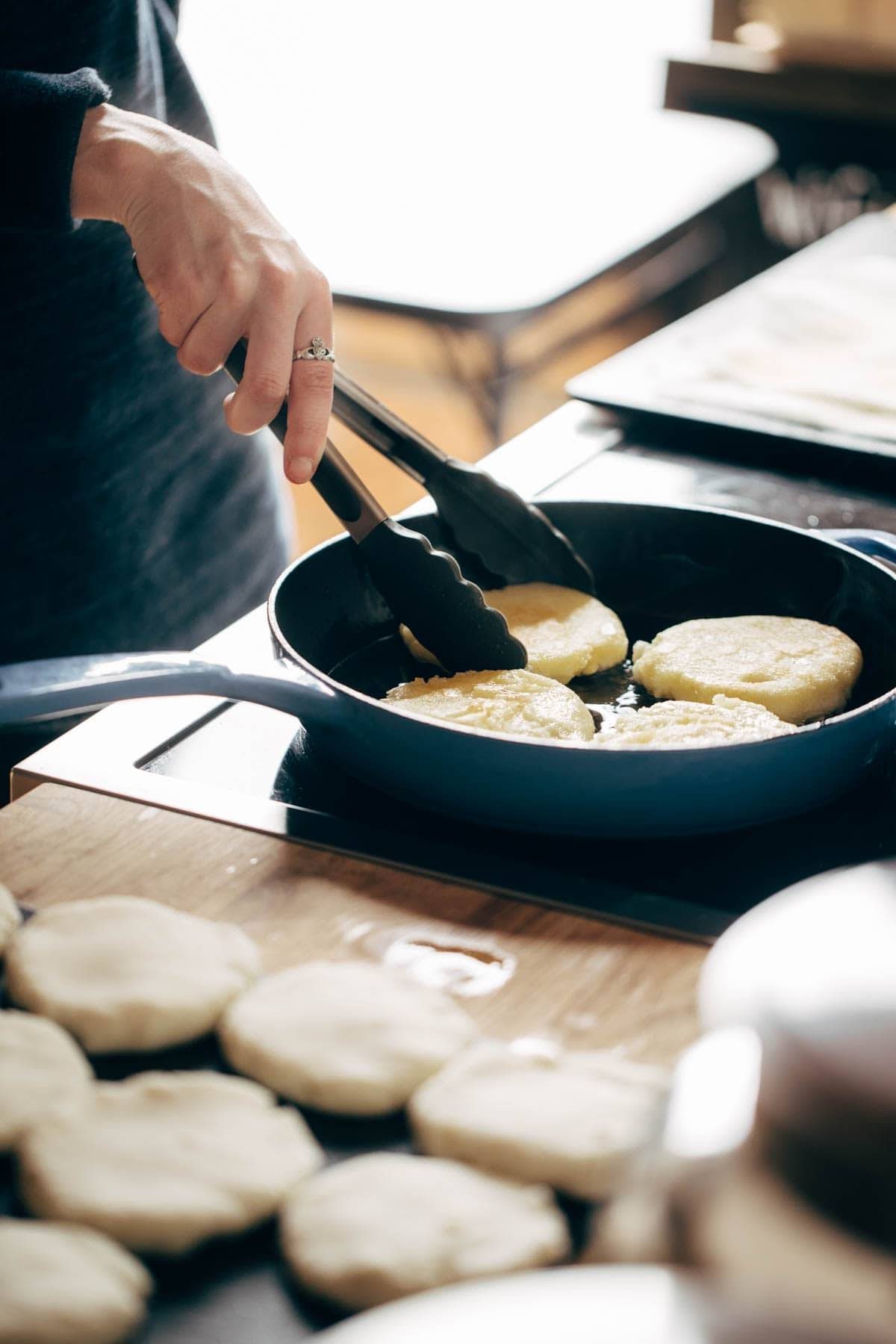 Frying Arepas in a pan.
