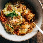 Spaghetti with roasted zucchini in a bowl with a fork.