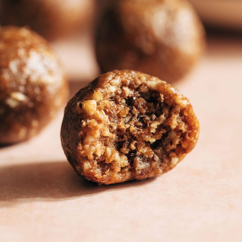 Pecan pie energy bite with a bite taken out of it