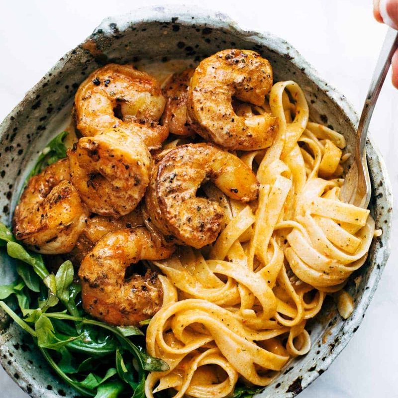 Red Pepper Fettuccine in a bowl with shrimp.