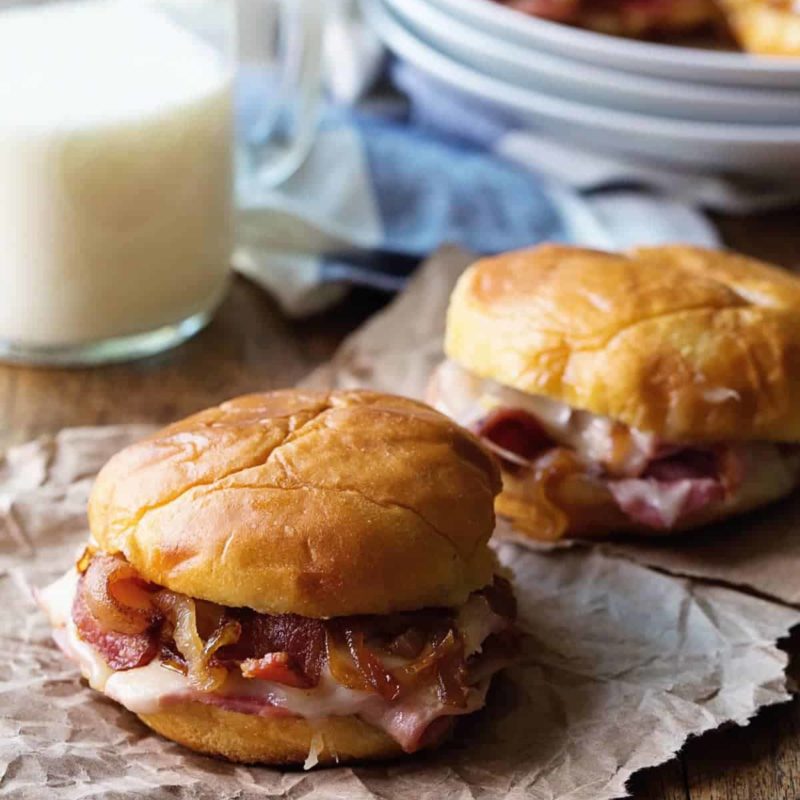 A picture of Hot Ham and Cheese Sandwiches with Bacon and Caramelized Onions