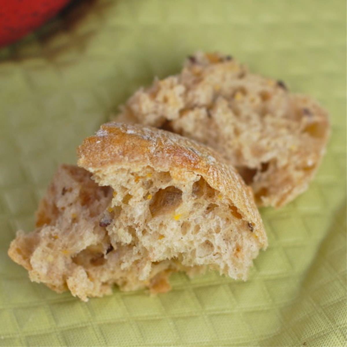Pieces of bread on a green napkin.