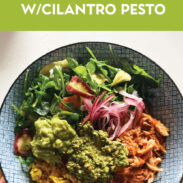 Chicken bowls with yellow rice, greens, onions, and cilantro pesto.