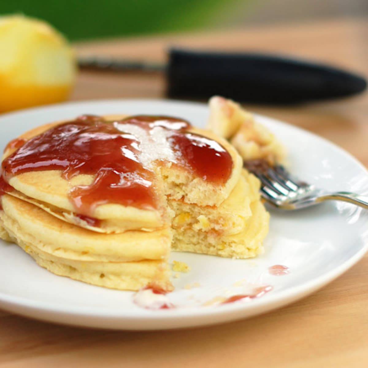 Lemon Pancakes topped with a blackberry syrup made from blackberry jam.