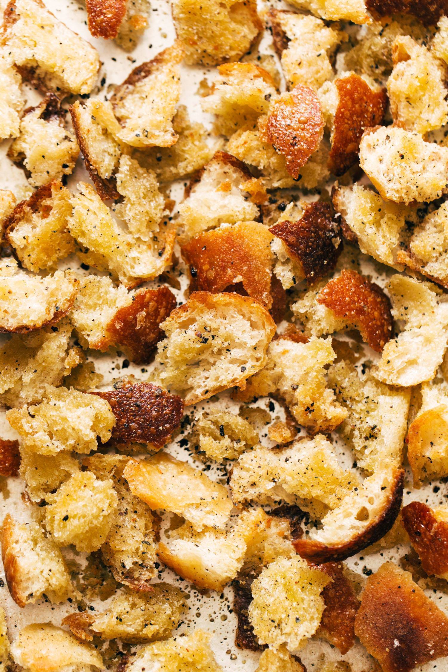 Peppery croutons on a sheet pan with olive oil.