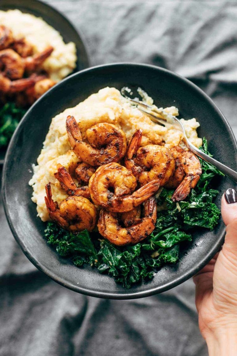 Spicy shrimp in a bowl with cauliflower mash and kale.