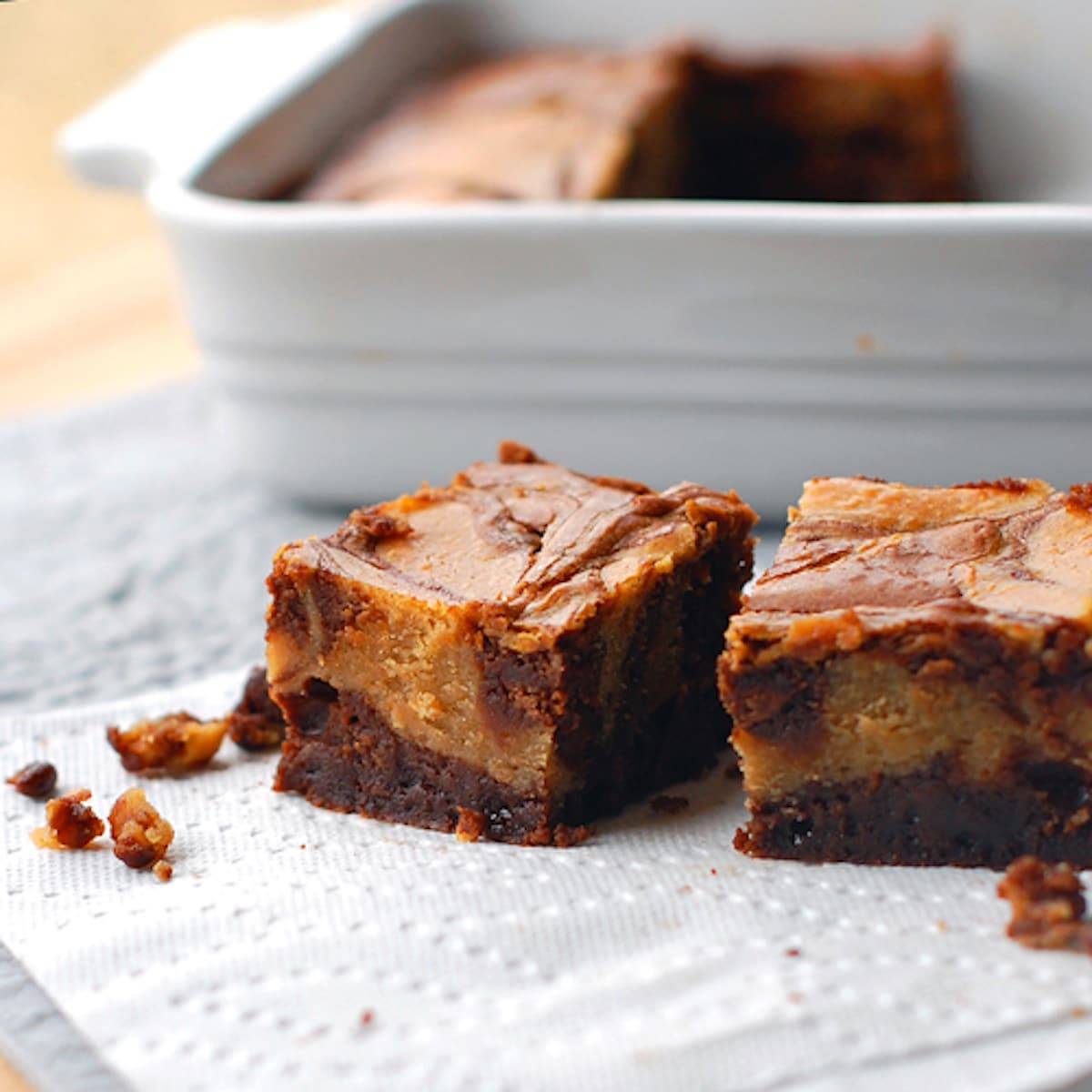 Peanut butter cheesecake brownies on a napkin.